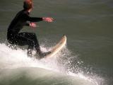 Surfer off the pier at Pismo Beach, California