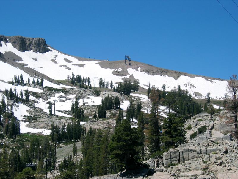 The monument is to the left of the ski lift
