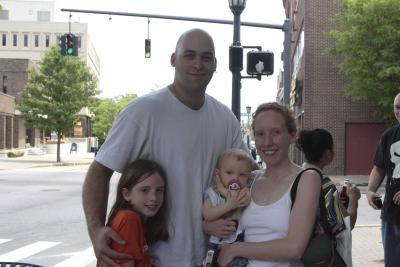 The perp is feed and poses with his family.