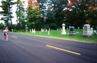 Relay runner passing a cemetery