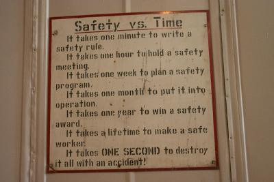 An old, undated safety sign posted in the roundhouse workshops.
