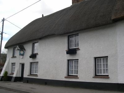 Clock on cottage wall, Wiltshire