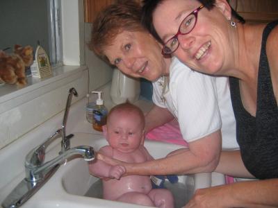 Great-grandma and Grammy Pammy giving tay a bath