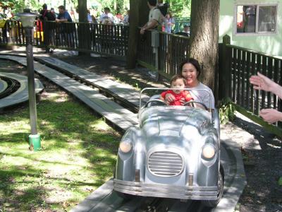 Mommy and Kyle riding the cars at Knoble's Grove