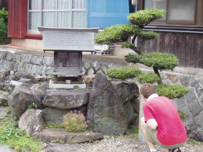 Ben inspects one of the many small ojizosans that line the roads of Yamamoto village
