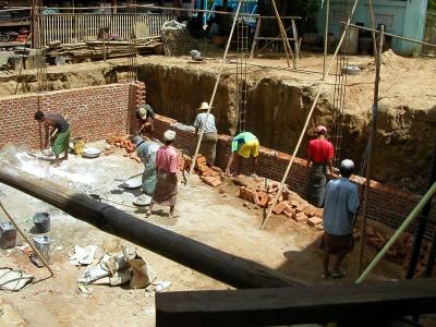 Men in longyi digging a cellar for aging lacquer