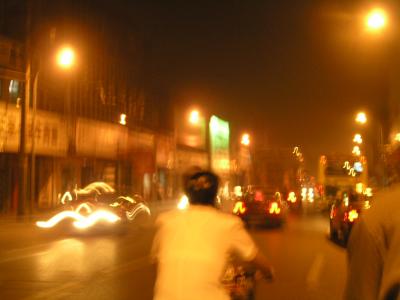 riding a velo-riksha at night