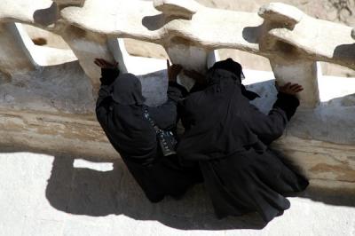 Three Yemeni women covered head to toe