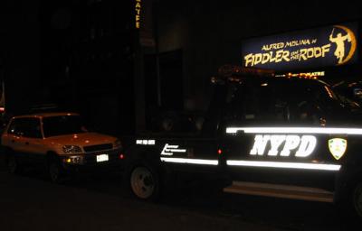 NYPD towing a car on Broadway