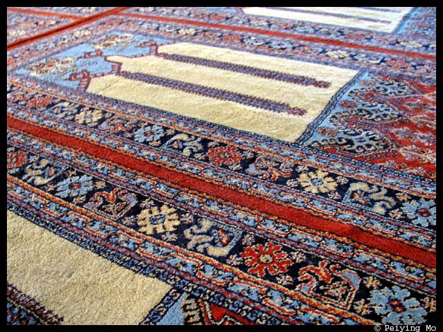 Prayer rug runs from wall to wall