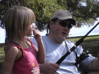 Mike shows Kaelyn how to fish