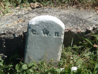pg_40 - Small Marker at Base of Fallen/Buried Headstone.  It may read C. W. B.