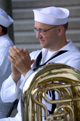 A member of navy Band Northwest applauding Washington State Senator Paull Shin