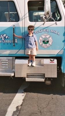 Another picture of Ben standing on the fire truck
