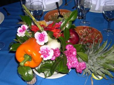 table centerpieces (made out of pineapples, with peppers, onions, and flowers)