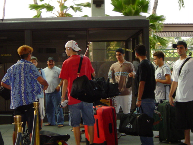 Boys waiting to check luggage