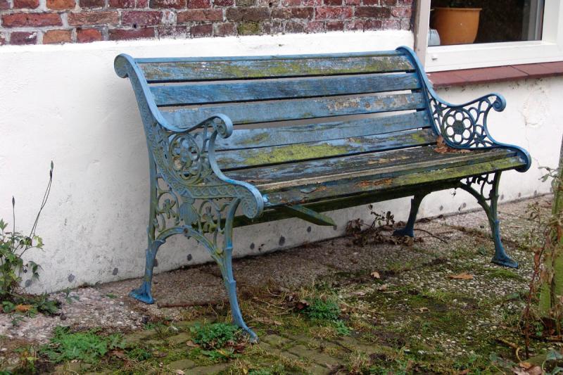 What's left of a blue bench