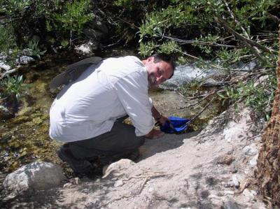 jay collecting water at outpost camp.JPG