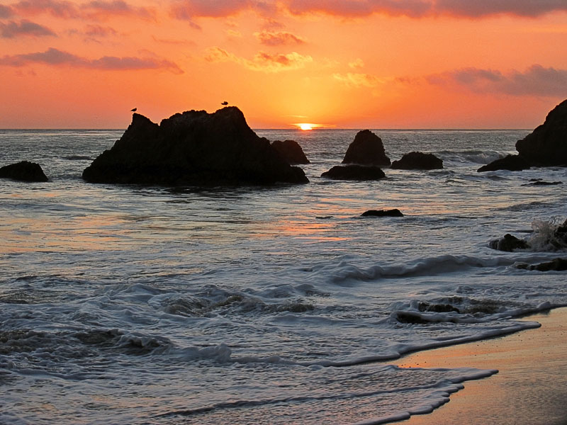 Sunset behind rocks at El Matador Beach