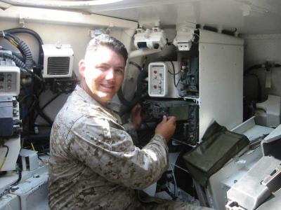 me SSgt Adlerz checking the radios in an M-1 tank