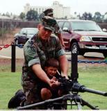 My Dad Warren took this photo of me with my Son Ian during a family day.  I had to assist Ian with the .50 calibur M2 gun