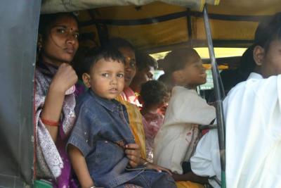 A family of at least 12 in a auto rickshaw