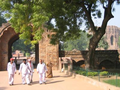 Indian men walk throug the gate