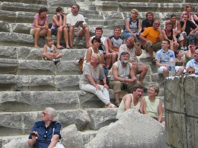 A guided European group, on a probablyrare rest break, inspects the theater.