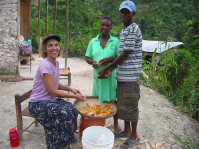 Rachel helping one of the local women shell corn