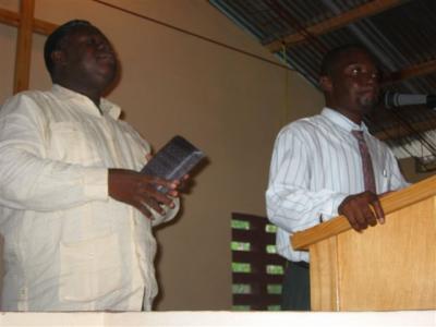 man to the Right is preaching and man on the Left is translating to English for us