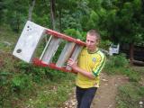 carrying all thigns off of the truck up the hill to the church site