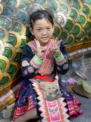 Cute hill tribe sitting along the stairway of Wat Phra That Doi Suthep