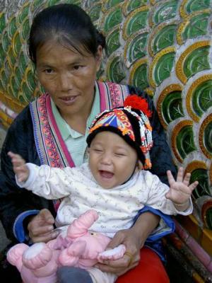 A baby hill tribe with her mother the sacred staircase of Wat Phra That Doi Suthep