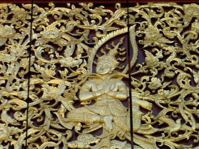A wood carving with gold painted Lanna artwork at Wat Chedi Luang