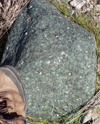 Multifaceted boulder near my foot