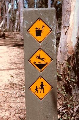 Another weird sign by the Parks department - watch the cliffs, ground is slippery, and watch out for kids?