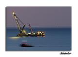 Sea Horizon by night and moving tug.