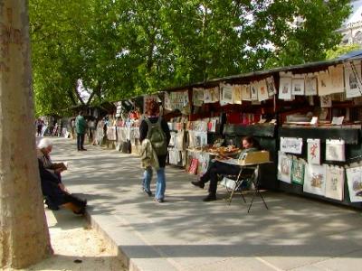 Vendors with their stalls in front of the wall near the Seine River. Vendors like this have been here since medieval times.