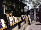 A stall in front of the wall near the Seine River. Primarily books, photos & art for sale at these stalls.