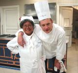A very tall chef & a very short student