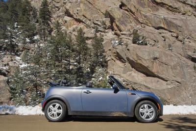 A MINI Convertible appears to leave a trail of trees in its wake.