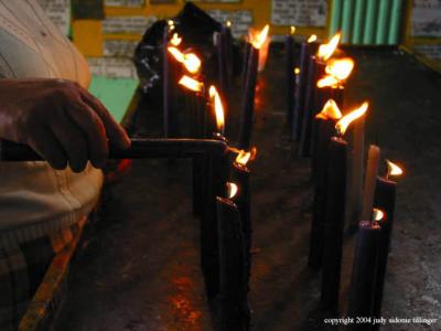 lighting candles, san andreas iztapa, guatemala