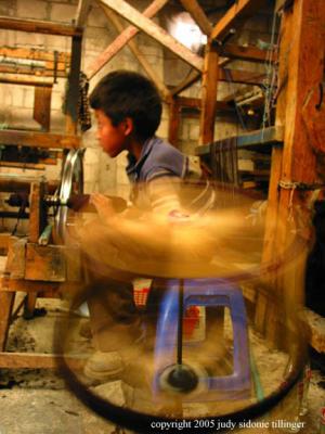 boy spinning yarn, sta maria de jesus, guatemala