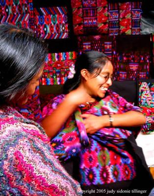 selling huipiles in chichicastenango, guatemala