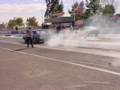 GTO and Camaro burn out