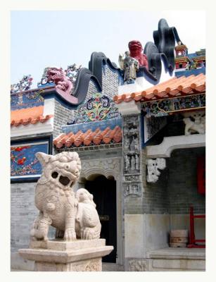 A stone statue guards Pak Tai Temple