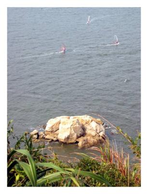 the dumpling rock and wind surfers