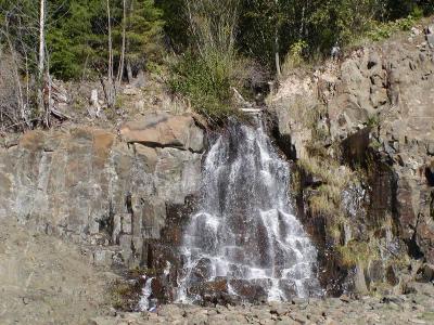 waterfall on the side of the road