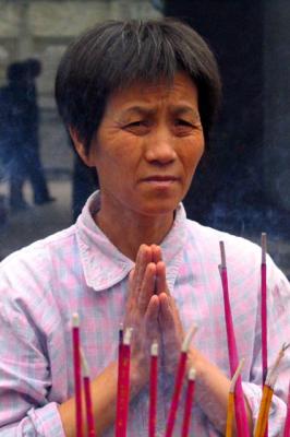 Praying at buddhist temple in Chengdu
