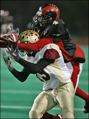 09-Bridgeport Central reciever goes over the back of New Britian defender to make the catch.jpg